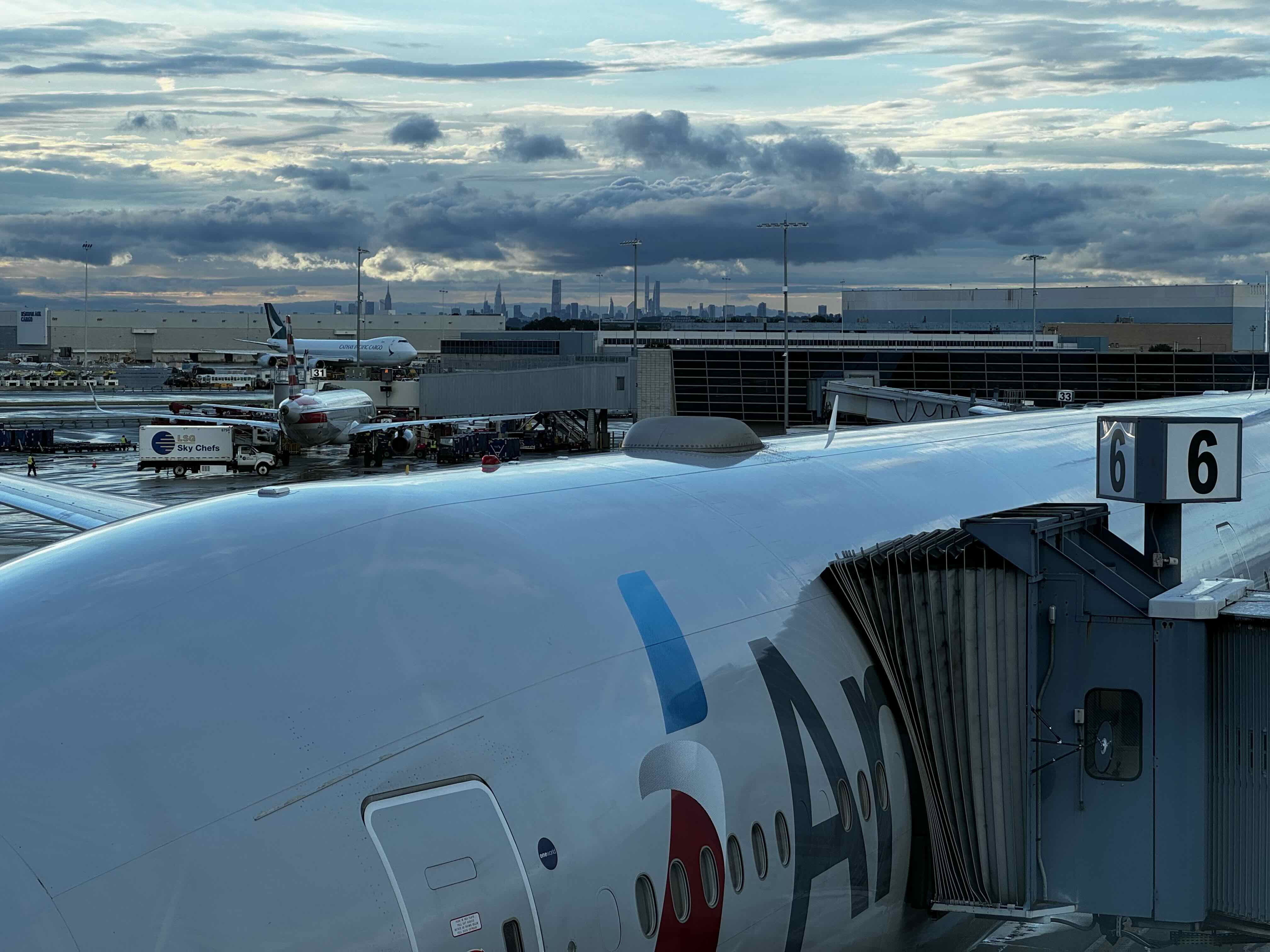 Plane with NYC Skyline in the Horizon at JFK Airport_ NYC